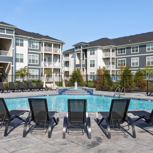 a pool with chairs around it
