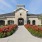 a clubhouse with a garden in front of it