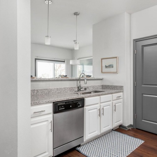 a kitchen with a white cabinets and a sink